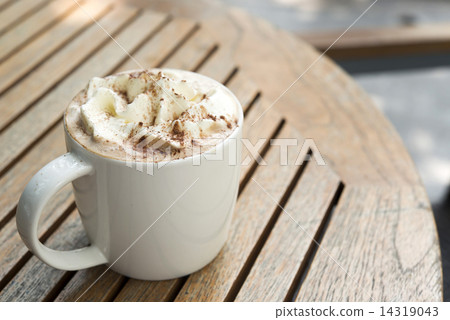 Cup of hot Chocolate topping with whipping cream and cocoa powde 14319043