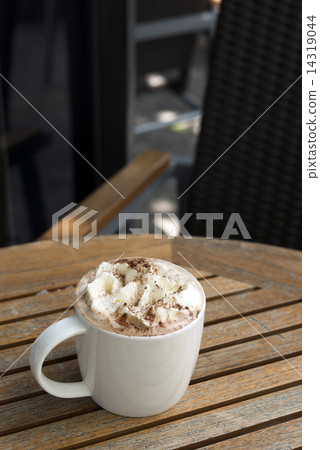 Cup of hot Chocolate topping with whipping cream and cocoa powde 14319044