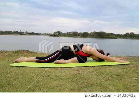 Young woman doing yoga exercise 14320422