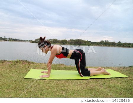 Young woman doing yoga exercise 14320426