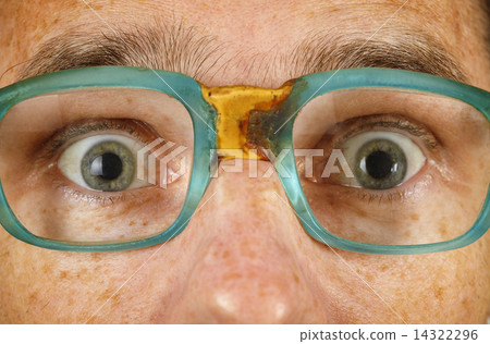 Eyes of surprised person in old spectacles Eyes of surprised person in old spectacles 14322296