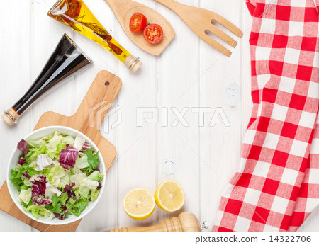 Fresh healthy salad and condiments over white wooden table Fresh healthy salad and condiments over white wooden table 14322706