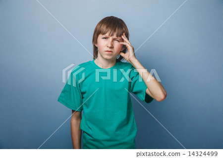 Boy, teenager, twelve years old, in a green t-shirt holding  14324499