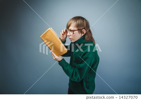 teenager boy brown hair European appearance in green sweater wit 14327070