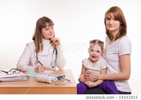 Pediatrician, the child and his mother are sitting at the desk in the office Pediatrician, the child and his mother are sitting at the desk in the office 14331915