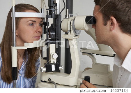 Woman Having Sight Test At Opticians Woman Having Sight Test At Opticians 14337184
