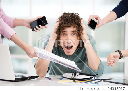 Shocked young businessman with hands around him 14337917
