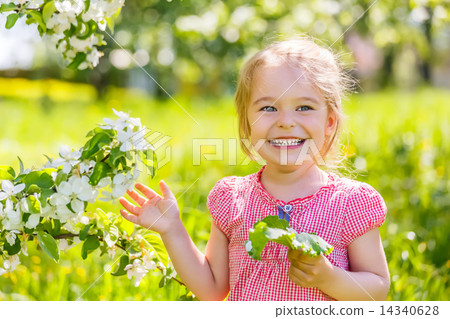 Happy little girl in spring sunny park 14340628