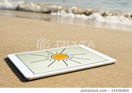 sun drawn in a tablet in the sand of a beach 14346864