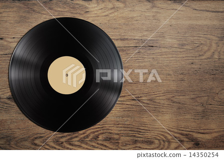 vynil record disc on wooden table 14350254