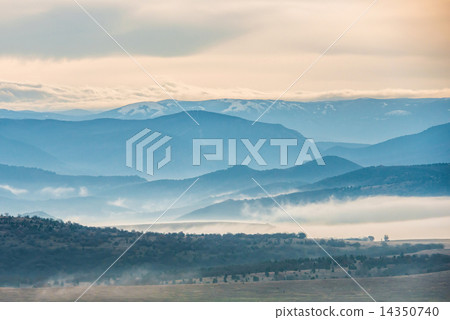 Blue mountains covered with mist 14350740