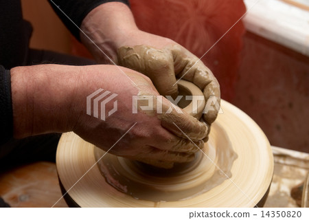 Hands forming clay pot 14350820