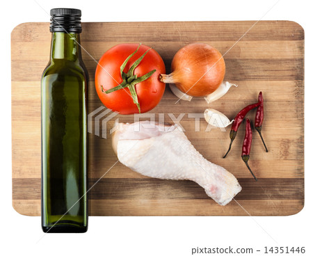 raw chicken leg on a wooden board and vegetables 14351446