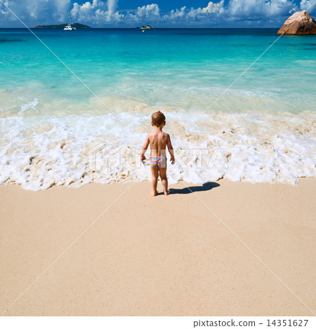 Two year old boy playing on beach Two year old boy playing on beach 14351627