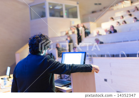 Speaker giving talk on podium at Business Conference. 14352347