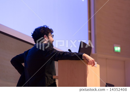 Speaker giving talk on podium at Business Conference. Speaker giving talk on podium at Business Conference. 14352408