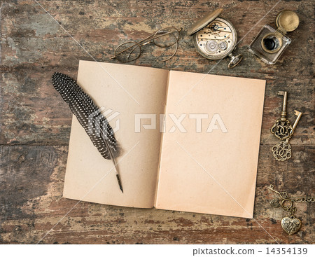 Open book and vintage writing accessories. Textured wooden backg 14354139