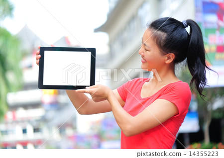 young asian woman hold blank digital tablet on shopping street young asian woman hold blank digital tablet on shopping street 14355223