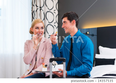 Man and woman arriving in hotel room 14357535