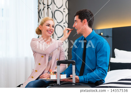 Man and woman arriving in hotel room 14357536