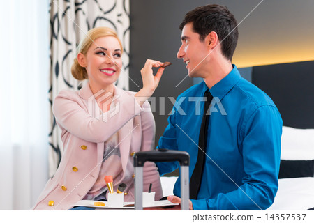 Man and woman arriving in hotel room 14357537