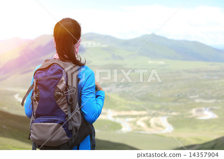 cheering hiking woman enjoy the beautiful view at mountain peak in tibet,china  14357904