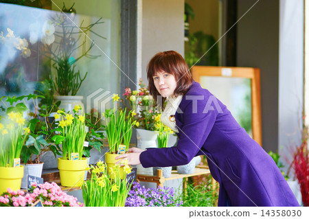 Girl selecting flowers in a Parisian flower shop Girl selecting flowers in a Parisian flower shop 14358030