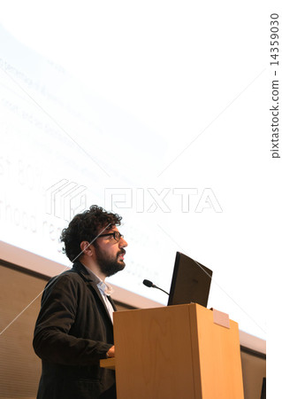 Speaker giving talk on podium at Business Conference. 14359030