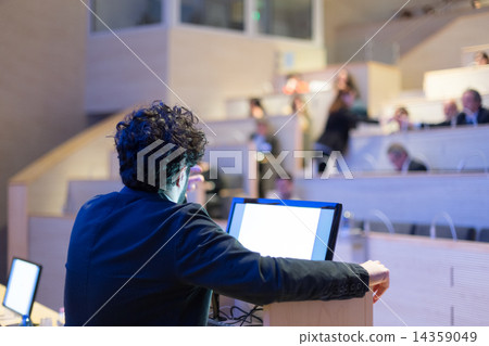 Speaker giving talk on podium at Business Conference. 14359049