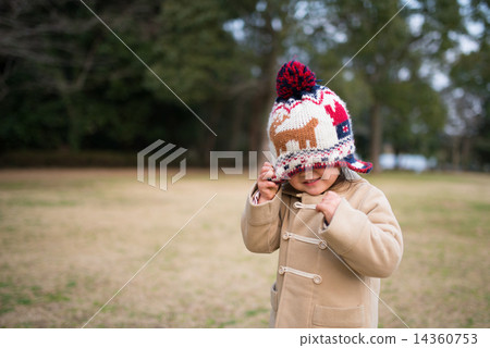 A girl hiding his face with a knit cap 14360753