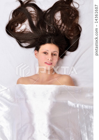 Beautiful woman on the bed under white linen. Beautiful woman on the bed under white linen. 14361687