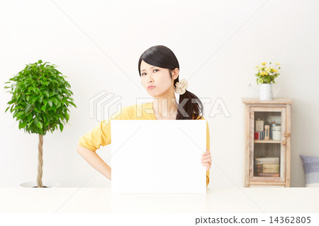 A woman angry with a message board 14362805