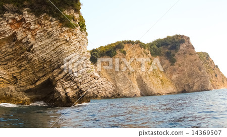 Rocks over the transparent ocean water Rocks over the transparent ocean water 14369507