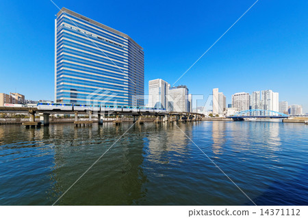 Monorail and skyscrapers passing near Tennozu Isle Station 14371112