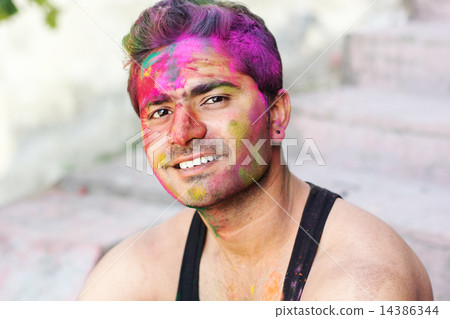 Portrait of Indian guy with colorful paint on face 14386344