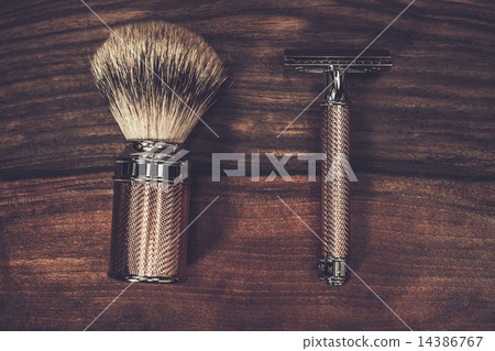 Safety razor and shaving brush on a wooden background Safety razor and shaving brush on a wooden background 14386767