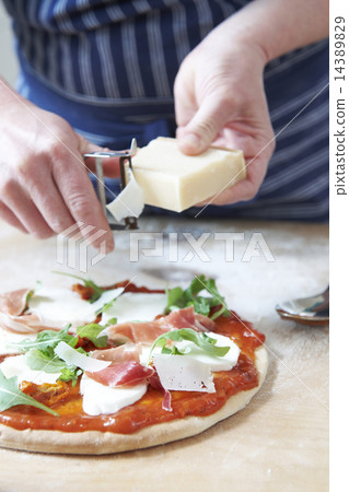 Adding Ingredients To Home Made Pizza Base 14389829