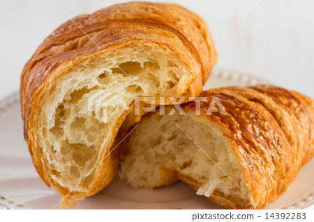 cut croissant on white table 14392283