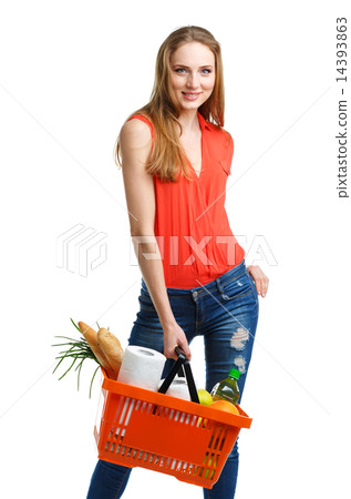 Woman with assorted grocery products in basket Woman with assorted grocery products in basket 14393863