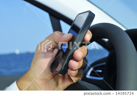 man using a smartphone while driving a car 14395714