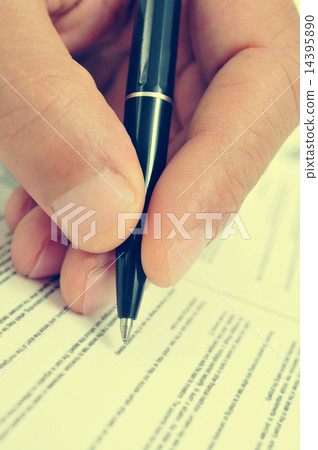 man hand with a pen, with a retro filter effect 14395890