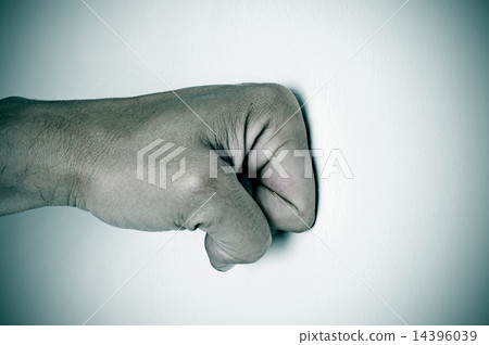 man fist punching a white surface man fist punching a white surface 14396039