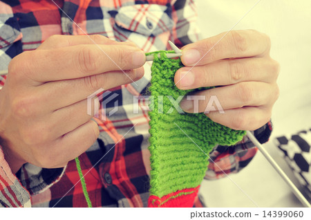 young man knitting 14399060