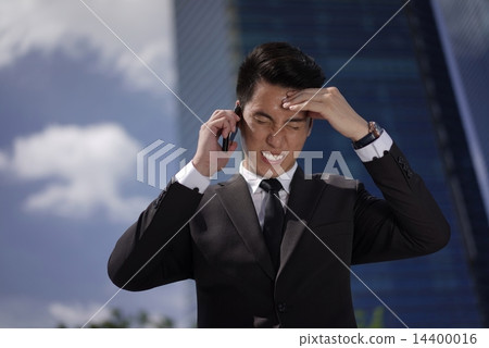 Man annoyed by news received over the phone Man annoyed by news received over the phone 14400016
