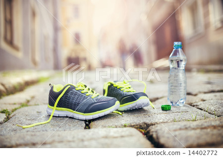 Running shoes and bottle of water 14402772