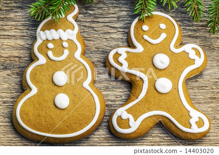 Christmas gingerbreads on a wooden table with fir  14403020