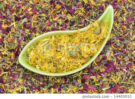 Dry calendula in green bowl with herbal tea around 14403031
