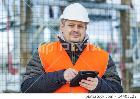 Electrical Engineer with tablet PC near the electr Electrical Engineer with tablet PC near the electr 14403122