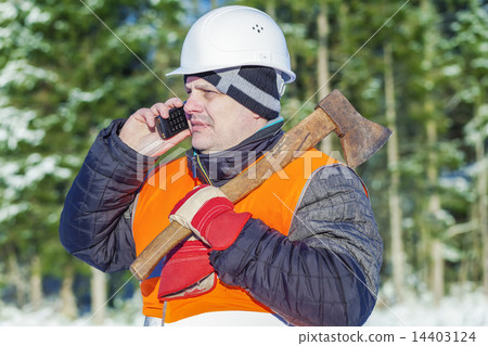Lumberjack in the forest in winter with an ax  14403124