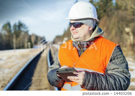 Railway employee with tablet PC near the railway  14403206